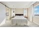 Bright main bedroom features tray ceilings, neutral walls, plush carpet, and a barn door leading to the ensuite bathroom at 20223 Terrace View Dr, Parker, CO 80134