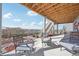 Covered patio area with outdoor seating overlooking the beautiful landscaped backyard at 20223 Terrace View Dr, Parker, CO 80134