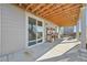 Covered outdoor patio space featuring wood beam ceiling, a sliding door, and potting bench at 20223 Terrace View Dr, Parker, CO 80134