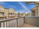 View from the balcony looking out to townhomes on a sunny day with blue skies at 12898 King St, Broomfield, CO 80020