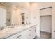 Elegant bathroom featuring double sinks with marble countertops and a large mirror at 12898 King St, Broomfield, CO 80020