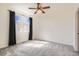 Light-filled bedroom with plush carpet, a ceiling fan, and large windows at 12898 King St, Broomfield, CO 80020