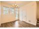 Spacious dining room with wood floors, a hanging chandelier, and natural light from the windows at 12898 King St, Broomfield, CO 80020