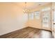 Dining area with a chandelier, wood flooring, and a glass door, that offers view of the neighborhood at 12898 King St, Broomfield, CO 80020