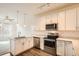 Bright kitchen featuring white cabinets, stainless steel appliances, and wood flooring at 12898 King St, Broomfield, CO 80020