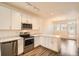 Open kitchen with white cabinetry, stainless steel appliances, and modern lighting fixtures at 12898 King St, Broomfield, CO 80020