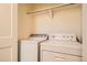 Functional laundry room features a white washer and dryer with shelf above at 12898 King St, Broomfield, CO 80020