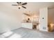 Open-concept floor plan with carpeted living area seamlessly connected to a modern kitchen space at 12898 King St, Broomfield, CO 80020