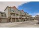 Street view of several townhomes, each with private balconies, garages and neutral exterior colors at 12898 King St, Broomfield, CO 80020