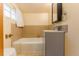Bathroom featuring a tile backsplash over vanity, updated sink and fixtures, and tub with tile surround at 4850 Forest Hill Rd, Evergreen, CO 80439