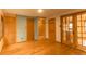 Spacious bedroom with hardwood floors, a tiled shower stall, and bright natural lighting at 4850 Forest Hill Rd, Evergreen, CO 80439