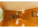 Bright living room featuring a stone fireplace and natural wood paneling at 4850 Forest Hill Rd, Evergreen, CO 80439