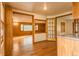 Spacious living room featuring wood paneled walls and hardwood floors at 4850 Forest Hill Rd, Evergreen, CO 80439