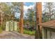 View of the home's exterior featuring a green storage shed on a private lot at 4850 Forest Hill Rd, Evergreen, CO 80439