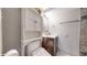 Bright bathroom features a vanity with ample storage and a toilet with built-in shelving at 7103 Depew Ct, Arvada, CO 80003