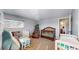 Neutral-toned room featuring a large bookshelf, cribs, and a play area at 7103 Depew Ct, Arvada, CO 80003