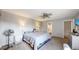 Bedroom featuring neutral walls, carpet, ceiling fan, and a private ensuite bathroom at 7103 Depew Ct, Arvada, CO 80003