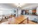 Dining area with wooden table and a view of the kitchen and cozy living room at 7103 Depew Ct, Arvada, CO 80003