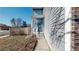 Charming front entrance with decorative glass door and blue siding, providing a welcoming curb appeal at 7103 Depew Ct, Arvada, CO 80003