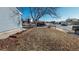 Landscaped front yard with a walkway leading to the home, wooden border and green space at 7103 Depew Ct, Arvada, CO 80003