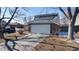 Two-story home with a two-car garage, solar panels and a concrete driveway at 7103 Depew Ct, Arvada, CO 80003