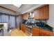 Well-lit kitchen with stainless steel appliances, dark countertops and wooden cabinetry at 7103 Depew Ct, Arvada, CO 80003