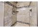 Spa-like shower featuring tiled walls with decorative mosaic trim and a built-in niche at 7103 Depew Ct, Arvada, CO 80003