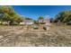 Large backyard and meadow featuring an area with a fire pit, garden boxes, and a shed at 18128 Sage Brush Way, Brighton, CO 80603