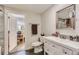 Bright bathroom features a white vanity, neutral walls, and a framed mirror at 18128 Sage Brush Way, Brighton, CO 80603