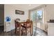 Cozy dining area with a table and chairs, near sliding glass doors at 18128 Sage Brush Way, Brighton, CO 80603