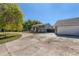 Ranch style home with a large driveway and mature tree in the front yard at 18128 Sage Brush Way, Brighton, CO 80603