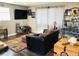 Comfortable living room with a large television, couch and eclectic decor at 18128 Sage Brush Way, Brighton, CO 80603