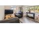 Spacious living room featuring hardwood floors and a large window at 18128 Sage Brush Way, Brighton, CO 80603