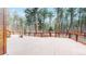 Backyard deck with wood railing overlooking trees at 12655 Greenland Acres Rd, Larkspur, CO 80118