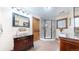 Bathroom featuring a glass enclosed shower, tiled floors, and wood vanity at 12655 Greenland Acres Rd, Larkspur, CO 80118