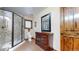 Bathroom features a glass enclosed shower, tiled floors, and wood vanity at 12655 Greenland Acres Rd, Larkspur, CO 80118