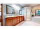 Spacious bathroom features a double vanity, soaking tub, and separate shower with tile surround at 12655 Greenland Acres Rd, Larkspur, CO 80118