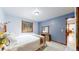 Bright bedroom with blue accent wall, wood trim, and view of the outdoors at 12655 Greenland Acres Rd, Larkspur, CO 80118