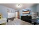 This bedroom has a whiteboard and cube storage, a wooden door, and a TV mounted on the wall at 12655 Greenland Acres Rd, Larkspur, CO 80118