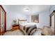 Bedroom featuring wood furniture, large window, and warm natural light at 12655 Greenland Acres Rd, Larkspur, CO 80118