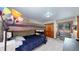 Bedroom with bunkbeds, dresser, and window with views of the outdoors at 12655 Greenland Acres Rd, Larkspur, CO 80118