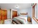 Cozy bedroom with wood accents, a colorful quilt, and lots of natural light at 12655 Greenland Acres Rd, Larkspur, CO 80118