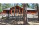 This beautiful home has a deck that is perfect for relaxing and entertaining, surrounded by lush trees at 12655 Greenland Acres Rd, Larkspur, CO 80118