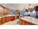 Spacious kitchen with granite countertops and wood cabinets at 12655 Greenland Acres Rd, Larkspur, CO 80118
