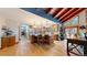 Open kitchen with wood floors, breakfast bar, stainless steel appliances, and exposed beam vaulted ceilings at 12655 Greenland Acres Rd, Larkspur, CO 80118