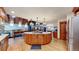 Spacious kitchen boasts a large island with granite counters, wooden cabinets, and modern lighting fixtures at 12655 Greenland Acres Rd, Larkspur, CO 80118
