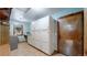 This laundry room has a window and a set of storage cabinets with a counter at 12655 Greenland Acres Rd, Larkspur, CO 80118