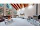Inviting living room with vaulted ceilings, fireplace, and large windows at 12655 Greenland Acres Rd, Larkspur, CO 80118