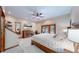 Spacious main bedroom with wooden trim, a fan, and direct backyard access at 12655 Greenland Acres Rd, Larkspur, CO 80118