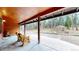 Covered patio with wood ceiling and concrete flooring perfect for enjoying nature at 12655 Greenland Acres Rd, Larkspur, CO 80118